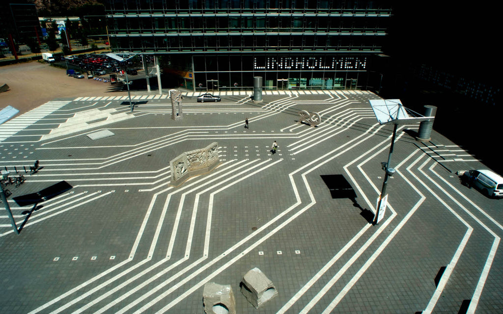 Superplattan i svart och vit super, lagd i ett elegant mönster på ett torg som skapar stark kontrast och modern karaktär. Stengrossen säljer produkten. Tillverkad av S:T Eriks